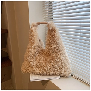 Detail of beige faux fur tote bag showing plush texture and smooth brown handle