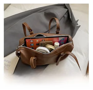 Interior view of brown retro handbag showing spacious capacity for tablet and cosmetics