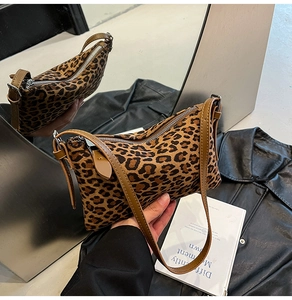 Detail of leopard print faux fur handbag with adjustable leather strap and silver buckle
