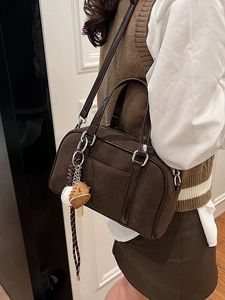 Brown suede Boston bag for women with baseball charm and woven shoulder strap