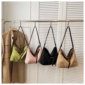 Detail view of large quilted tote bags in green, pink, black and khaki with adjustable straps