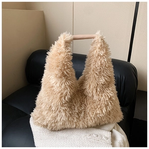 Detailed texture of beige plush hobo bag showing soft faux fur and smooth handle
