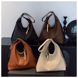 Detailed display of four textured leather tote bags in black, brown, tan, and beige colors