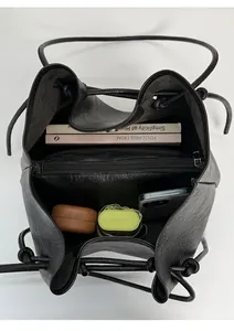 Top view showing the spacious interior of the black leather bucket bag with compartments