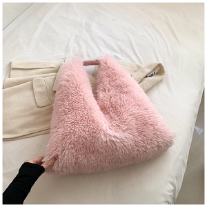 Detailed close-up of a plush pink faux fur tote bag with a soft and fluffy texture