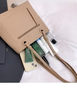 Flat lay of a beige tote bag showing its large capacity for makeup and daily essentials
