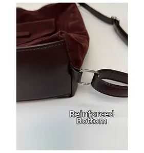 Detail showing the thickened bottom of the vintage burgundy tote with silver hardware