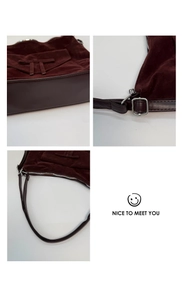 Macro detail of burgundy suede shoulder bag showing silver buckles and leather texture
