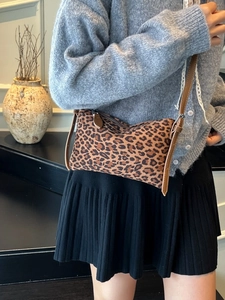 Leopard print underarm bag with brown leather strap for autumn winter commute outfit