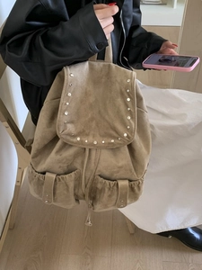 Khaki suede backpack with silver rivets and dual front pockets for women's daily commute