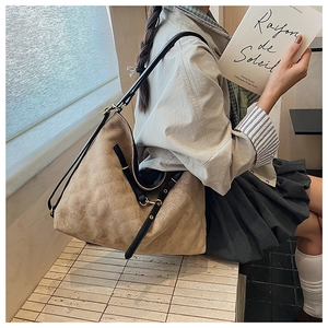 Quilted suede shoulder bag featuring classic rhombic stitching and black leather strap