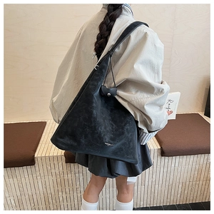 Détail du grand sac cabas noir mat avec logo Fashion & Bags porté par mannequin