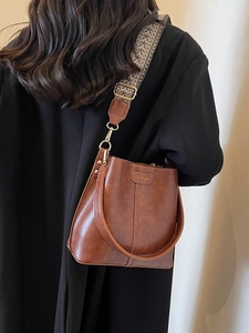 Retro dark brown bucket bag with vintage wide bohemian strap for stylish women