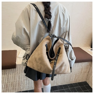 Detailed back view of a khaki quilted rhombus backpack with black leather straps