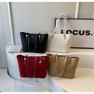 Macro shot of minimalist tote bags in black beige burgundy and khaki with gold logo details