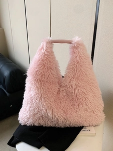 Pink plush tote bag with leather handles shown on a white stool for autumn winter style