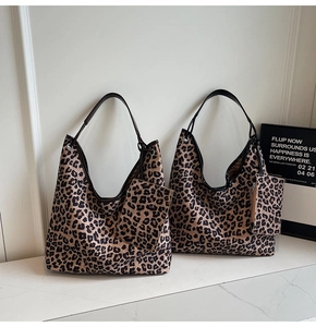 Detail of leopard print tote bags with matching coin purses on marble surface