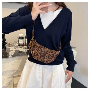 Detailed leopard print crescent bag with wooden bead tassels and long leather shoulder strap