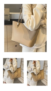 Detailed macro view of minimalist tote bag featuring premium beige leather and gold hardware