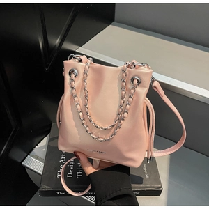 Pink faux leather bucket bag with silver chain handle and adjustable shoulder strap