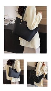 Close-up of black matte leather tote bag with thin shoulder straps and gold logo detail