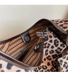 Detail of leopard nylon tote with magnetic buckle closure and striped lining
