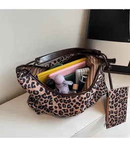 Detailed interior view of a leopard print tote bag filled with daily essentials