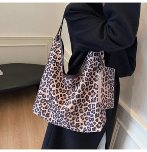 Detail view of the large leopard print tote bag with matching zipper pouch for women