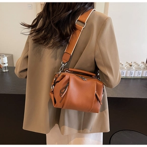 Detailed view of brown lychee texture shoulder bag with stylish wide strap and metal zip