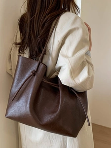 Deep brown oversized minimalist tote bag in matte faux leather with stylish drawstring knot