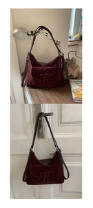 Macro detail of wine red suede hobo bag with vintage leather TT patch and silver buckle