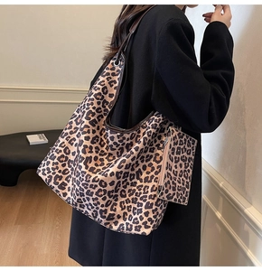Detail of large leopard print tote bag with matching coin purse and leather handles