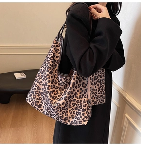 Close-up of leopard print tote bag featuring soft texture and matching mini zipper pouch