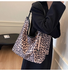 Detail of vintage leopard print tote bag with matching coin pouch and black trim straps