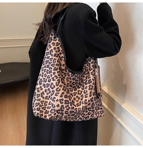 Detail view of the large leopard print tote bag and matching zip pouch attachment