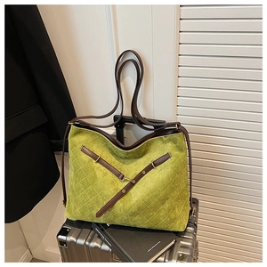 Close-up of mustard green quilted tote bag featuring retro diamond stitching and metal rings