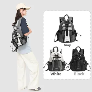 Mini outdoor nylon backpack in grey, white, and black with side mesh pockets and adjustable buckles