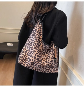 Leopard print tote bag showing the spacious interior and slouchy hobo style on model