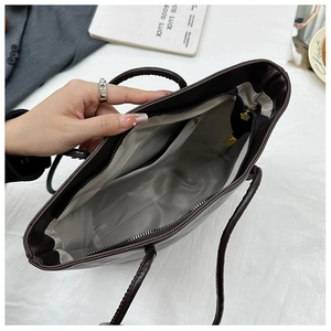 Detail view of large tote bag interior showing zipper pocket and spacious gray lining