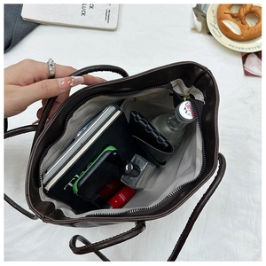 Interior view of large brown tote bag showing spacious storage with multiple daily essentials