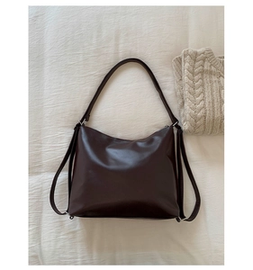 Top-down view of large dark brown leather hobo bag with oily finish and silver hardware