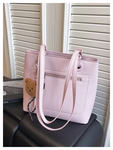Pink tote bag detail with back zipper pocket and cute brown plush bear charm