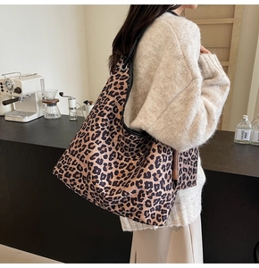 Detail of leopard print tote bag with mini pouch shown in a stylish lifestyle setting
