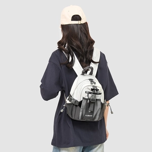 Rear view of a mini outdoor sports backpack featuring a white and grey color-block design