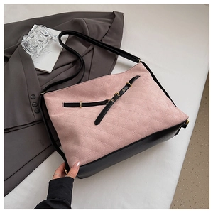 Detail of pink quilted suede and black leather patchwork bag with metallic buckle