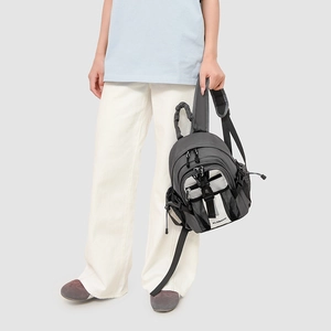 Close-up of compact grey outdoor backpack featuring white contrast pocket and KLEIMAN logo