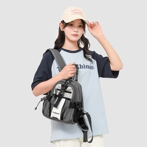 Close-up of minimalist mini sports backpack with adjustable buckles and mesh pocket