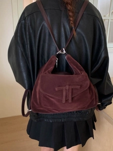 Retro burgundy suede backpack for women featuring a bow design and versatile shoulder straps