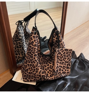 Detail view of large leopard print hobo tote bag with black leather handle and matching pouch