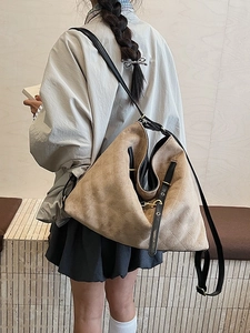 Quilted light brown faux suede tote bag for women with black leather straps on a model